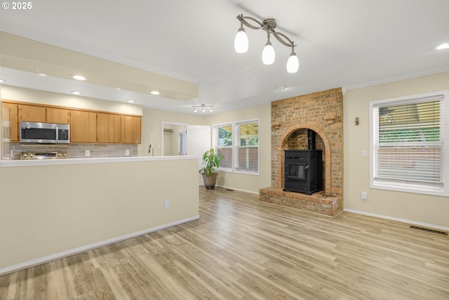 1255 NE 17th Ave, Hillsboro, OR 97124 - kitchen featuring stainless steel microwave, light wood-style floors, backsplash, light countertops, and recessed lighting