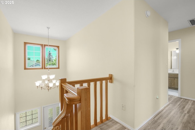 1255 NE 17th Ave, Hillsboro, OR 97124 - staircase featuring a chandelier and wood finished floors
