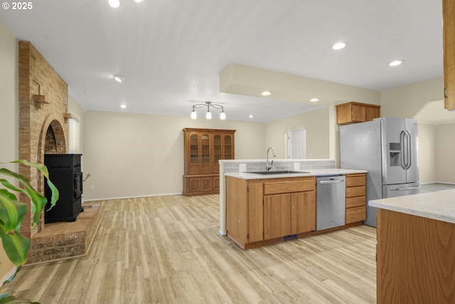 1255 NE 17th Ave, Hillsboro, OR 97124 - kitchen featuring appliances with stainless steel finishes, a peninsula, light wood finished floors, recessed lighting, and brown cabinetry