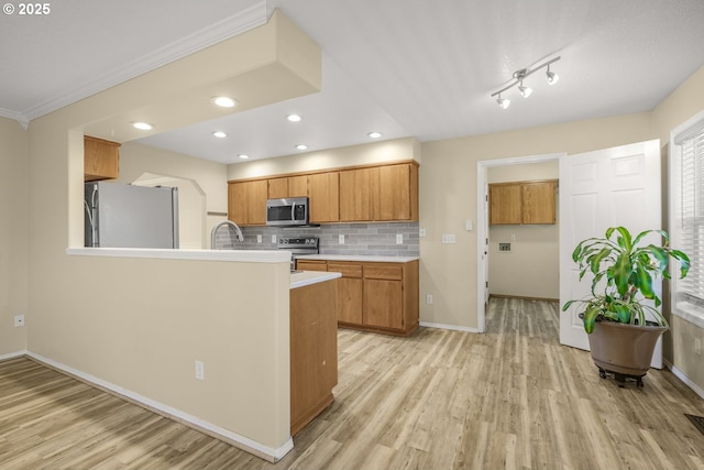1255 NE 17th Ave, Hillsboro, OR 97124 - kitchen featuring stainless steel appliances, light countertops, light wood-style floors, backsplash, and a peninsula