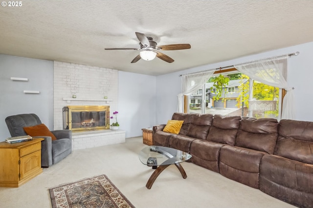 living room with light carpet, ceiling fan, a fireplace, and a textured ceiling