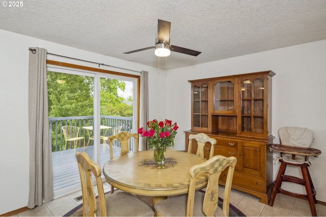 dining room featuring light tile patterned floors, ceiling fan, a textured ceiling, and baseboards