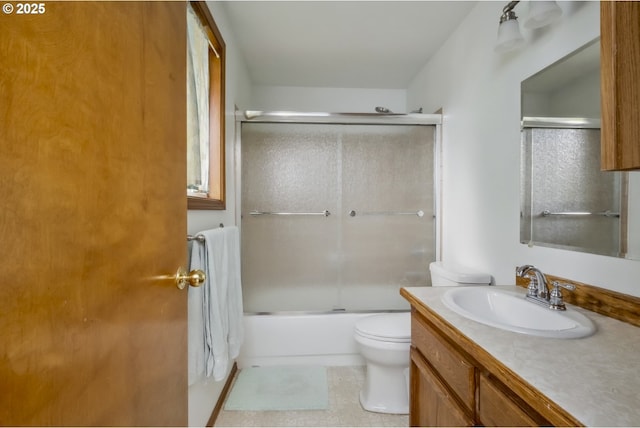 full bath featuring toilet, vanity, and enclosed tub / shower combo