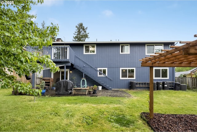 rear view of property with a pergola, stairway, and a wooden deck