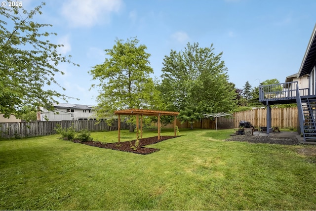 view of yard featuring a wooden deck and stairs