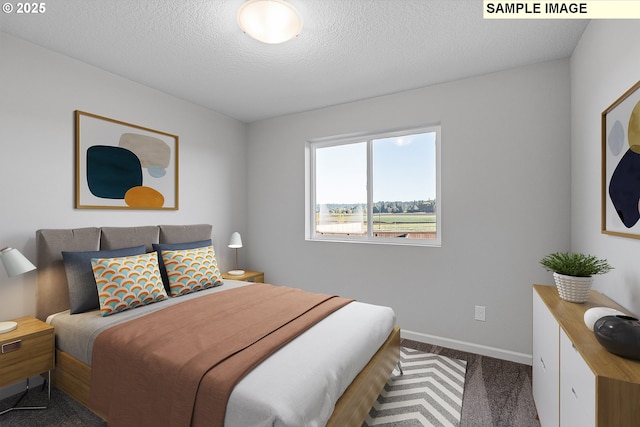 carpeted bedroom with a textured ceiling and baseboards