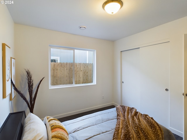 bedroom featuring baseboards and a closet