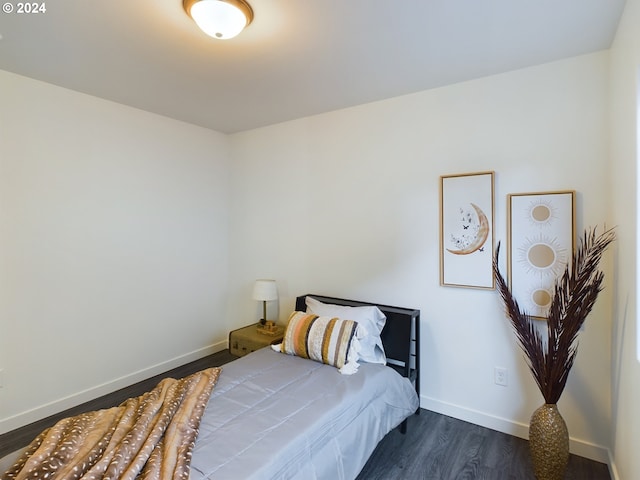 bedroom with dark wood-style floors and baseboards