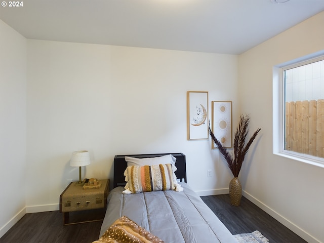 bedroom with dark wood finished floors and baseboards