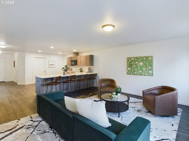 living area with recessed lighting, baseboards, and light wood-style floors