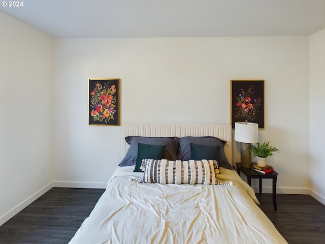 bedroom with wood finished floors and baseboards