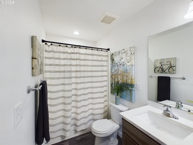 full bath with visible vents, toilet, wood finished floors, shower / bath combination with curtain, and vanity