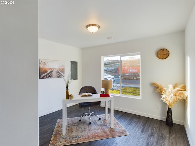 home office featuring electric panel, baseboards, and wood finished floors