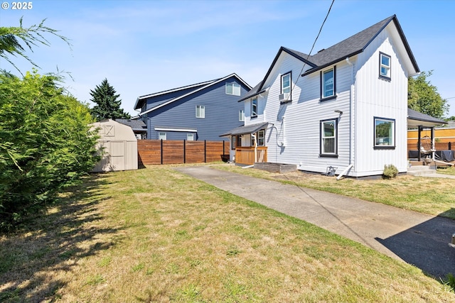 8007 N Hudson St, Portland, OR 97203 - back of property featuring a storage unit, board and batten siding, and driveway