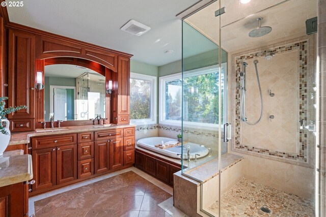 bathroom featuring a garden tub, a stall shower, and double vanity