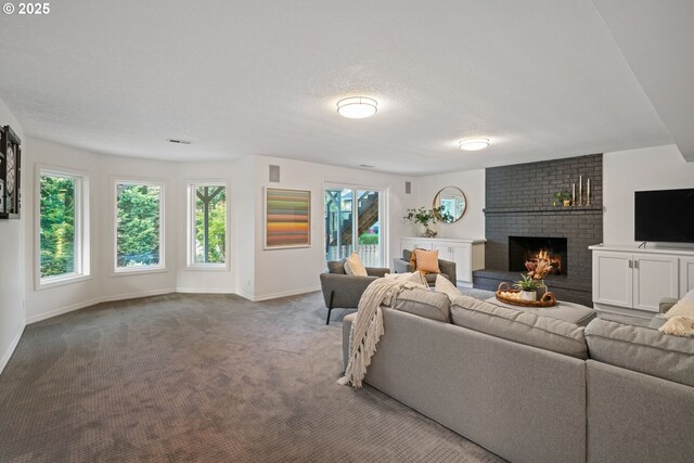 living area featuring baseboards, a brick fireplace, carpet, and a textured ceiling