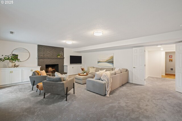 living area with light carpet and a brick fireplace
