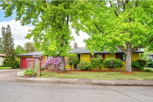 855 E 39th Ave, Eugene, OR 97405 - view of front of property with a garage, driveway, and a chimney