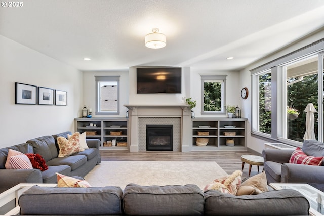 19294 Boulder Run Ct, Oregon City, OR 97045 - living room with wood finished floors, a glass covered fireplace, and recessed lighting