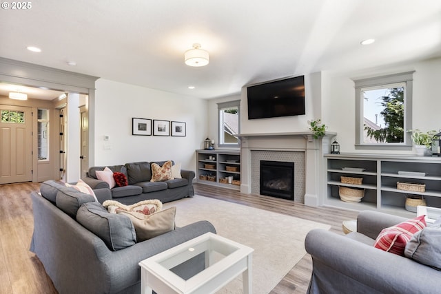 19294 Boulder Run Ct, Oregon City, OR 97045 - living room with wood finished floors, a glass covered fireplace, and recessed lighting