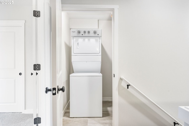 21190 SW Ortiz Ln, Beaverton, OR 97003 - clothes washing area with baseboards, stacked washer and dryer, and laundry area