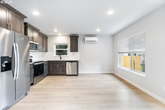21190 SW Ortiz Ln, Beaverton, OR 97003 - kitchen featuring dark brown cabinets, a wealth of natural light, a sink, and appliances with stainless steel finishes