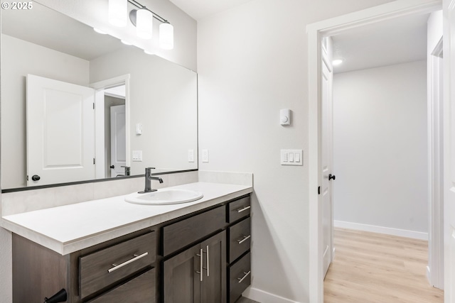 21190 SW Ortiz Ln, Beaverton, OR 97003 - bathroom with wood finished floors, vanity, and baseboards