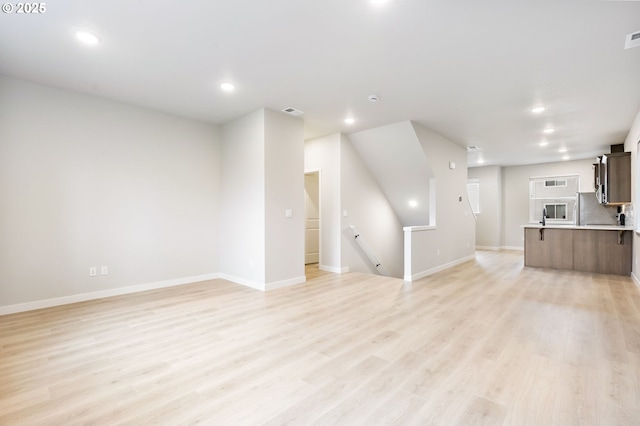 21190 SW Ortiz Ln, Beaverton, OR 97003 - unfurnished living room featuring baseboards, light wood-style floors, visible vents, and recessed lighting
