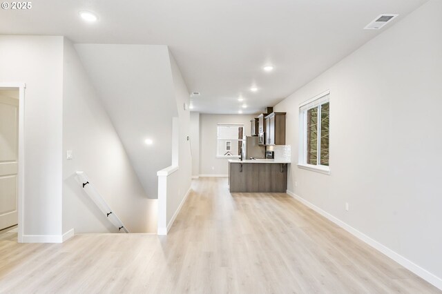 21190 SW Ortiz Ln, Beaverton, OR 97003 - kitchen with light wood-type flooring, light countertops, visible vents, and recessed lighting