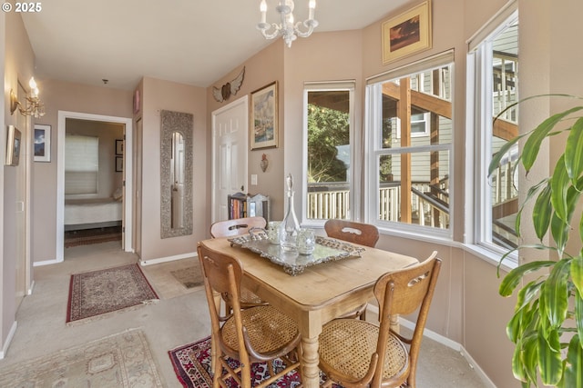 sunroom with healthy amount of natural light and a chandelier