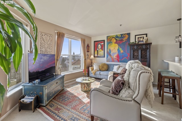 carpeted living area with baseboards