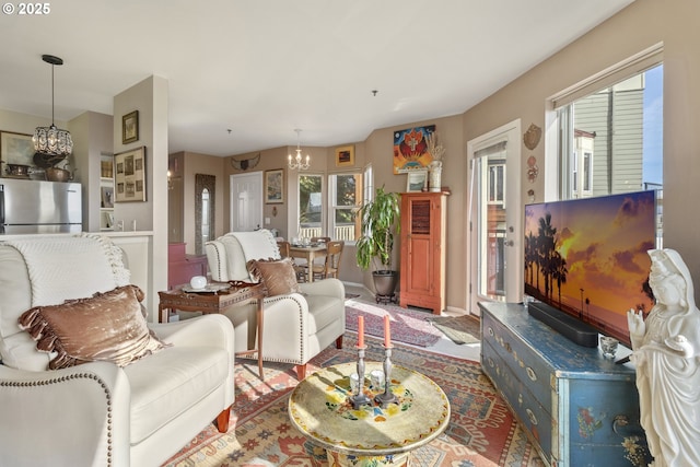 living room featuring a chandelier and plenty of natural light