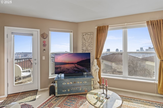 carpeted living area featuring baseboards