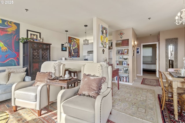 carpeted living area featuring a chandelier and built in shelves