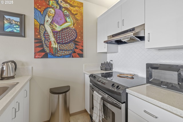 kitchen featuring under cabinet range hood, stainless steel electric range oven, backsplash, black microwave, and white cabinetry