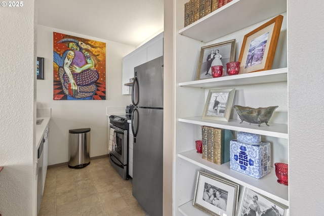 kitchen featuring appliances with stainless steel finishes, light countertops, and ventilation hood
