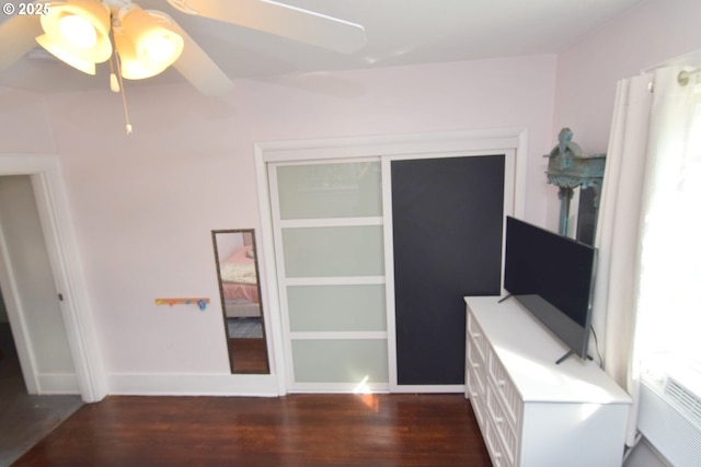 unfurnished bedroom featuring a ceiling fan, baseboards, and wood finished floors