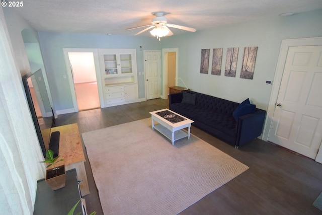living room with ceiling fan and wood finished floors