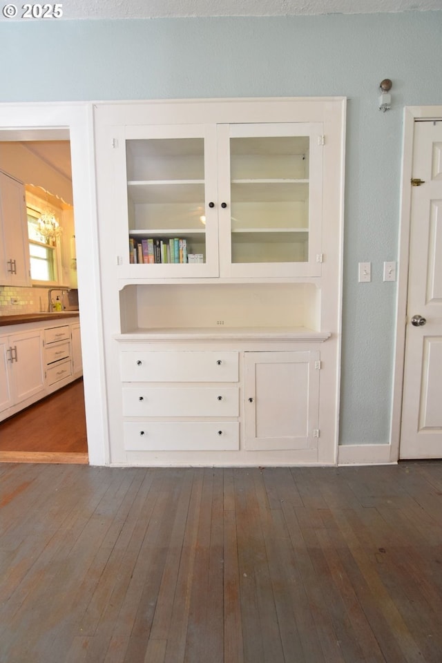 interior space featuring baseboards and wood finished floors