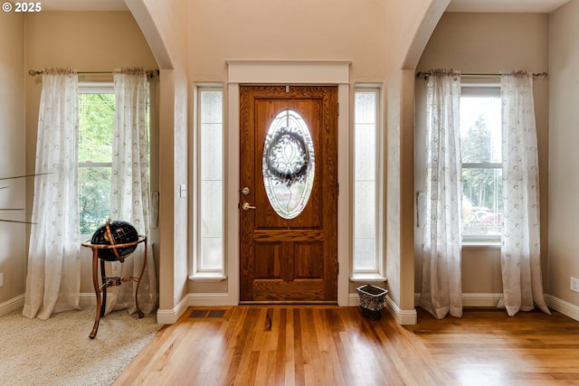 foyer entrance with plenty of natural light and light hardwood / wood-style floors