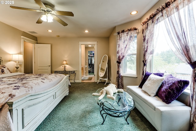 bedroom featuring multiple windows, ceiling fan, and dark colored carpet