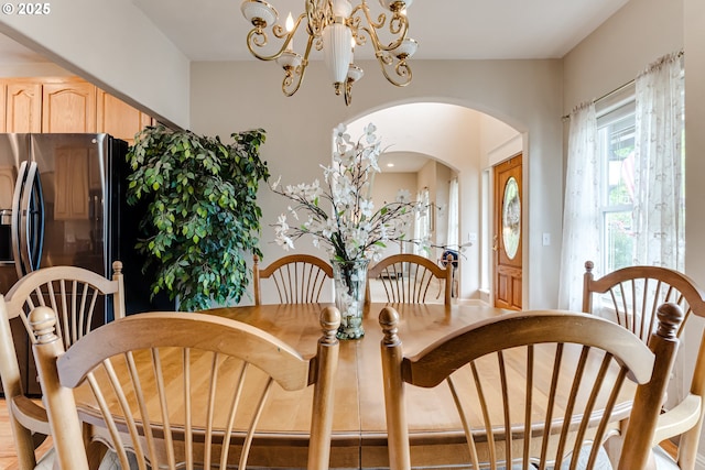 dining area featuring a notable chandelier