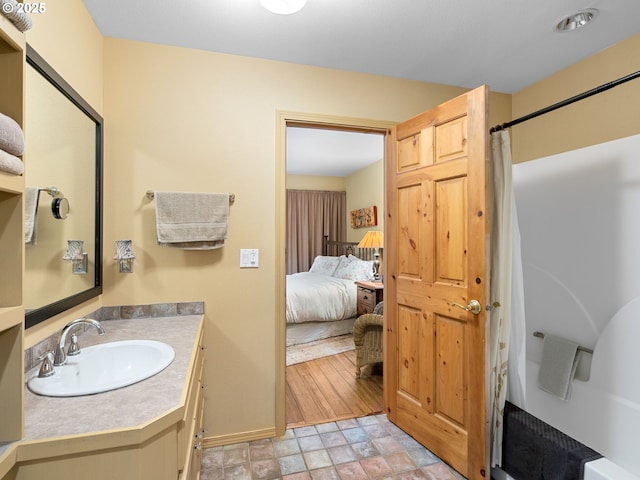33901 Merrill Creek Rd, Deer Island, OR 97054 - ensuite bathroom with stone finish floors, vanity, baseboards, and a shower with curtain