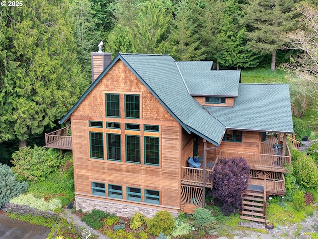 33901 Merrill Creek Rd, Deer Island, OR 97054 - view of front of home featuring a chimney, stairway, a shingled roof, and a wooded view