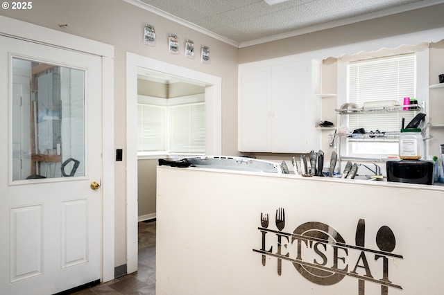 laundry room featuring crown molding and a textured ceiling