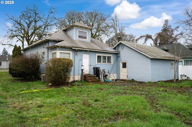 rear view of house with a yard