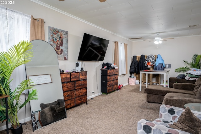 living room with ceiling fan, crown molding, and carpet floors