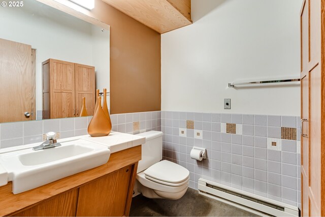 495 W 27th Ave, Eugene, OR 97405 - half bath featuring baseboard heating, toilet, tile walls, vanity, and a wainscoted wall