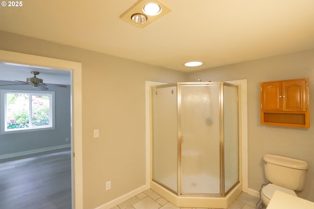 58798 Fairview Rd, Coquille, OR 97423 - bathroom featuring baseboards, a stall shower, toilet, and ceiling fan