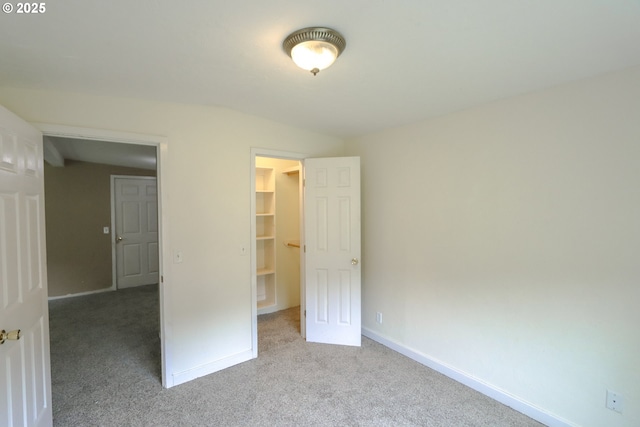 58798 Fairview Rd, Coquille, OR 97423 - unfurnished bedroom featuring carpet, a walk in closet, and baseboards